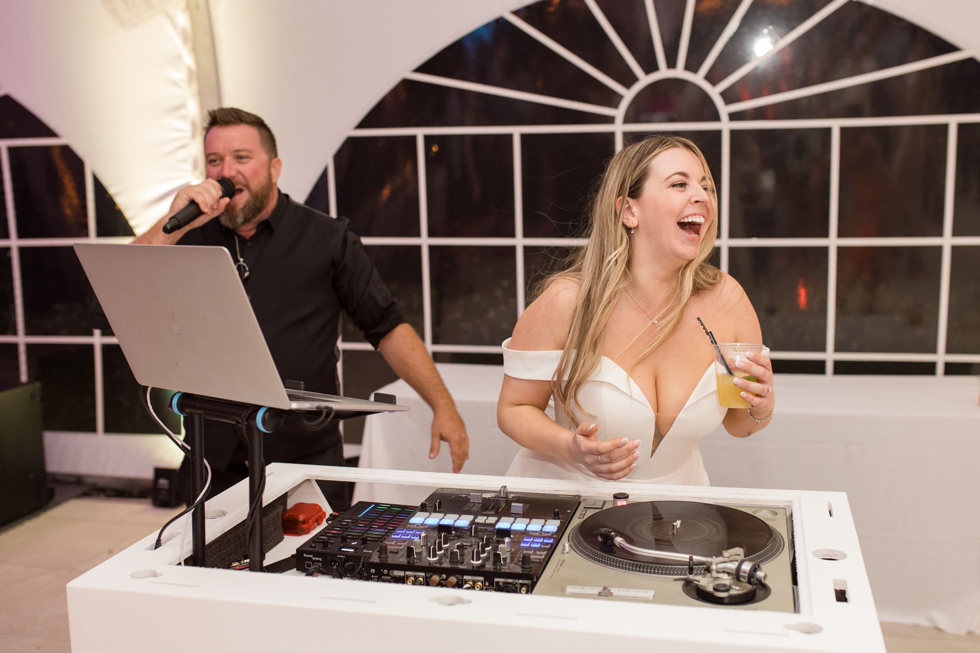 The DJ booth lit up as guests fill the dance floor